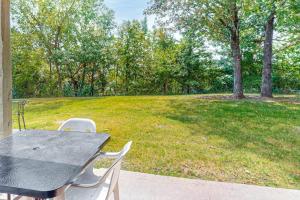 a table and chairs with a field of grass at Overlook Retreat, Apt. 3 in Branson