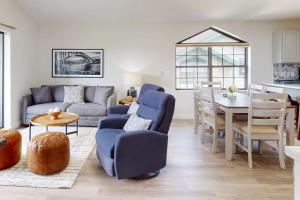 a living room with a blue couch and a table at Waterview Oasis in Branson