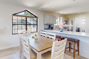 a kitchen and dining room with a wooden table and chairs at Waterview Oasis in Branson
