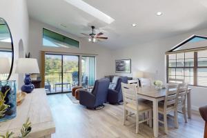 a dining room and living room with a table and chairs at Waterview Oasis in Branson