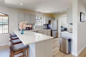 a kitchen with white cabinets and a counter with flowers on it at Waterview Oasis in Branson