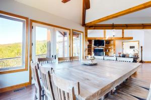 a large dining room with a large wooden table and chairs at Treetop View Sanctuary in Branson