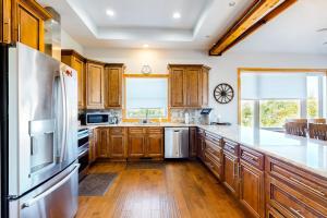 a kitchen with wooden cabinets and a white refrigerator at Treetop View Sanctuary in Branson