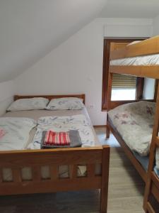 a bedroom with two bunk beds in a room at Apartmani Bele breze in Adlešiči