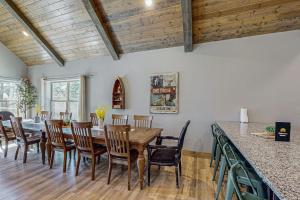 a dining room with a wooden table and chairs at Cozy Cove Lodge in Branson