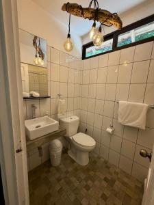 a bathroom with a toilet and a sink at Casita Gitza in Montezuma +39 photos
