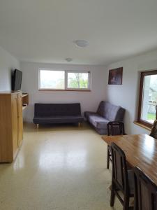 a living room with a couch and a table at Apartmani Bele breze in Adlešiči
