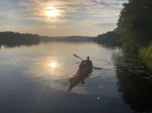 a man in a kayak on a lake at Dalälven Strand in Södersätra