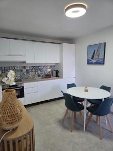a kitchen with a table and chairs in a room at A Casa di Minana in Piana