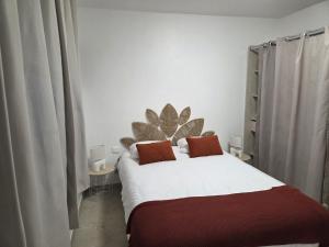 a bedroom with a large white bed with two pillows at A Casa di Minana in Piana