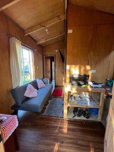 a living room of a tiny house with a couch at Cabañas Villegas C2 in Hornopiren