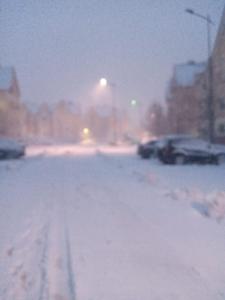 a snow covered street with cars parked in a parking lot at Irini in Ifrane +4 photos