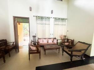 a living room with a couch and chairs and a table at Tea Estate Villa in Ratnapura +17 photos