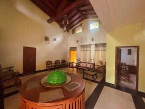 a living room with a table in the middle at Tea Estate Villa in Ratnapura
