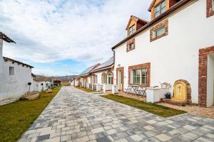 a cobblestone driveway in front of a white building at Red Stone in Kővágóörs