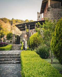 a garden with stone steps and a stone building at Hacienda Santa Maria Regla in Huasca de Ocampo
