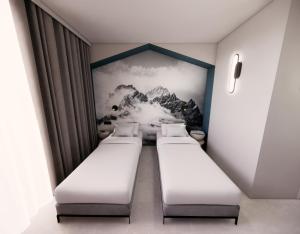 a row of beds in a room with a mountain mural at Kyriad - L'Isle D'Abeau Bourgoin Jallieu in LʼIsle-dʼAbeau