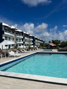 a large swimming pool in front of a hotel at Refúgio Cachoeira Guaibim in Guaibim