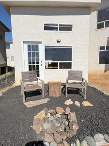 two benches sitting in front of a building at Casa Guilligan By Los Naufragos in El Bateque