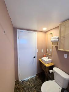 a bathroom with a toilet and a sink at Casa Guilligan By Los Naufragos in El Bateque +14 photos
