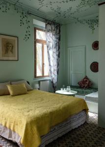 a bedroom with a large bed and a window at La Maison Tataouine in Moux