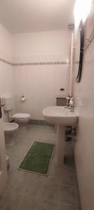 a white bathroom with a sink and a toilet at Alloggio Maia 2 in Biella