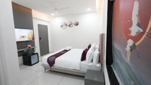 a bedroom with a bed and a bird on the wall at Hotel Flamount Hitech City in Hyderabad