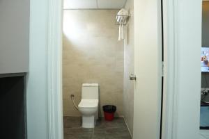 a bathroom with a white toilet in a room at Hotel Flamount Hitech City in Hyderabad +29 photos