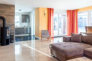 a living room with a couch and a kitchen at Villa Strandoase in Wohlenberg +32 photos