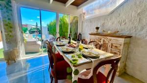 a dining room with a table and chairs and a fireplace at Marife Home in Guillena