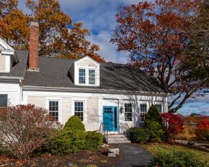 a white house with a blue door at The Manor Bed and Breakfast in Newcastle