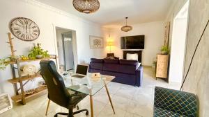 a living room with a couch and a table with a laptop at Marife Home in Guillena