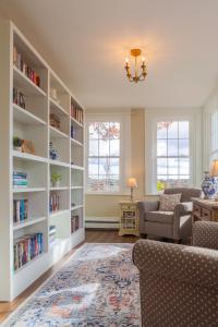 a living room with white bookshelves at The Manor Bed and Breakfast in Newcastle