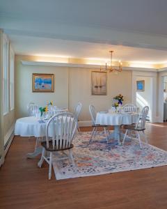 a dining room with two tables and chairs and a rug at The Manor Bed and Breakfast in Newcastle