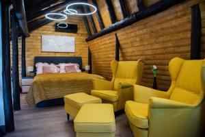 a bedroom with a bed and chairs in a room at Villa Dodo in Soboli +76 photos