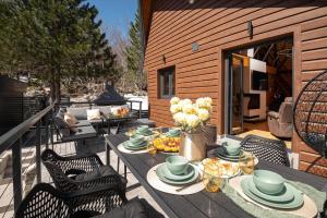 a table and chairs on a deck with a table and flowers at Villa Dodo in Soboli