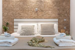 a bedroom with a bed with towels on it at Meraki Home in Lixouri