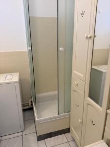 a shower with a glass door in a bathroom at Studio Horizon in Palavas-les-Flots
