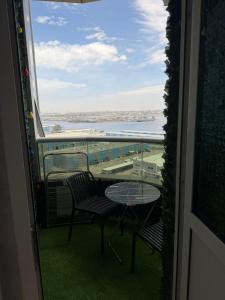 a view of a balcony with a table and chairs at High-floor Luxury Apartment! in Ajman 
