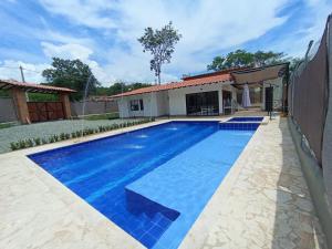 a swimming pool in front of a house at Villa Alma in Medellín