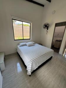 a bedroom with a bed in a room with a window at Villa Alma in Medellín +10 photos
