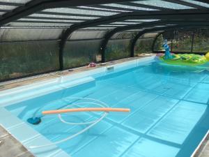 an indoor swimming pool with a pool noodle in the water at 15 min from Lyon Fresh Peaceful Room with Pool and Garden in Dardilly