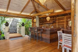 a kitchen with a bar in a house at Ocio Villas Mal Pais in Santa Teresa Beach