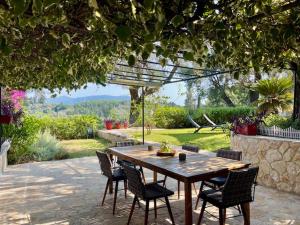 a wooden table and chairs on a patio at Mon Reve House in Corfu