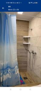 a bathroom with a shower with a blue shower curtain at ViV in Vorokhta +53 photos