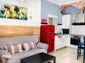 a living room with a couch and a red refrigerator at CASA ADELA - Playa 2 min - Aire Acondicionado - WIFI - Parking cercano in Barbate +15 photos