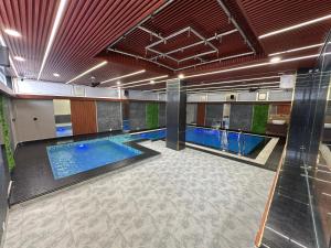 a pool in a building with a swimming pool at Aanchal Palace Hotel in Jaipur