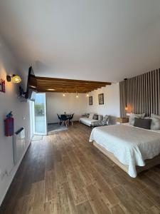 a large bedroom with a bed and a table at La casuca de Candela in Santillana del Mar