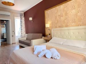 a bedroom with a bed with towels on it at Home Syrakos in Syracuse +43 photos