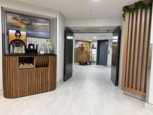 a hallway with a bar in a hotel room at Wingate by Wyndham Myrtle Beach At Outlets in Myrtle Beach